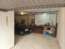 Garage underbuild with 1 of 2 cars parked inside